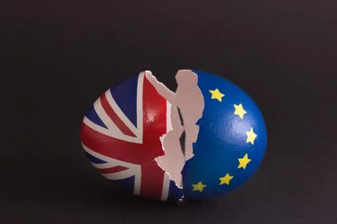 Two halves of cracked eggshell, one of which is decorated with the flag of Eu Stock Photos
