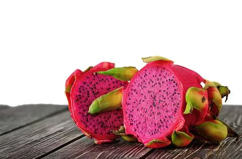 Two halves of dragon fruit on planks Stock Photos