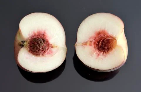 Two halves of one peach Stock Photos