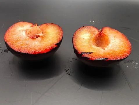 Two halves of a plum Stock Photos