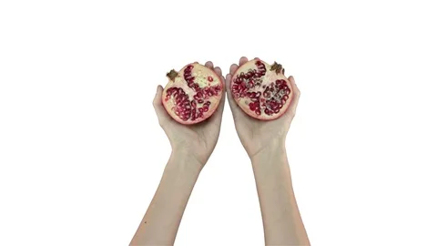 Two halves of pomegranate on white background. Video stock 71628569