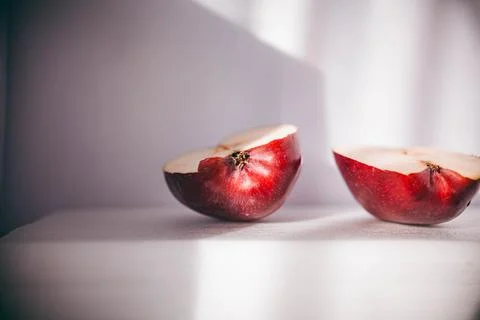 Two halves of a red apple on a white background Stock Photos