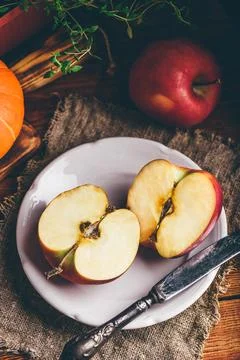 Two Halves of Red Apple on White Plate Stock Photos