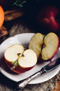 Two Halves of Red Apple on White Plate Stock Photos