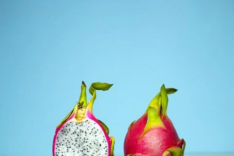 Two halves red dragon fruit pitahaya on a bright blue background, Vegan Stock Photos