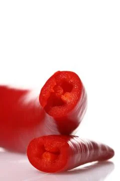 Two halves red hot chilli chilies pepper  on white Stock Photos