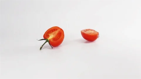 Two halves of tomato breaks hitting white surface Stock Footage 75961668