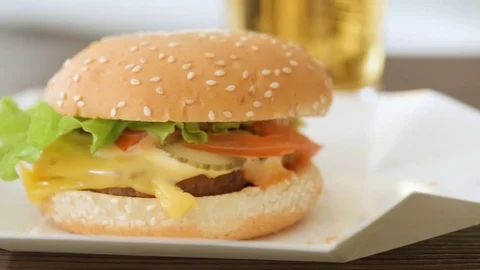 Two hamburger with fresh vegetables and beer glasses. 動画素材 85419053