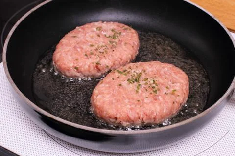 Two hamburger meat in pan Stock Photos