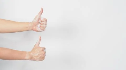 Two Hand with foam soap bubbles doing a like or thumbs up hand sign on white  Stock Photos