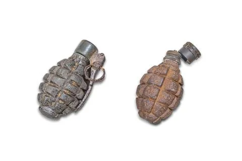 Two hand grenades on a beige textured surface Larger grenade in profile, dark Stock Photos