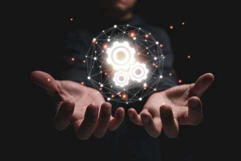 Two hand hold group of virtual cog gears wheel with connection Stock Photos