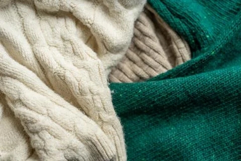 Two hand knitted wool sweaters. Background textures Stock Photos