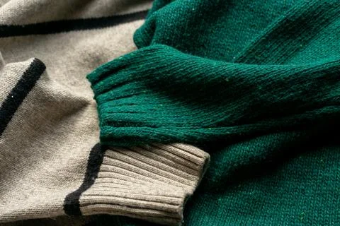 Two hand knitted wool sweaters. Background textures Foto stock