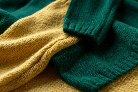 Two hand knitted wool sweaters. Background textures Stock Photos