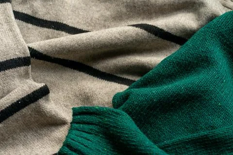 Two hand knitted wool sweaters. Background textures Foto stock