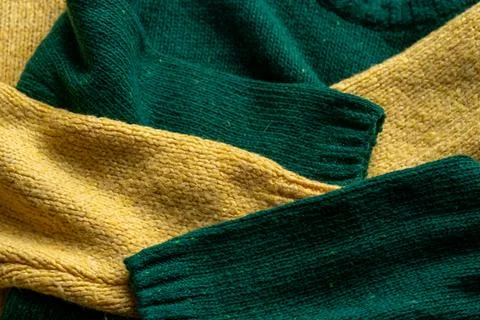 Two hand knitted wool sweaters. Background textures Stock Photos