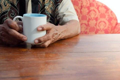 Two hand of senior elder on table, loneliness old man in living room with his Stock Photos