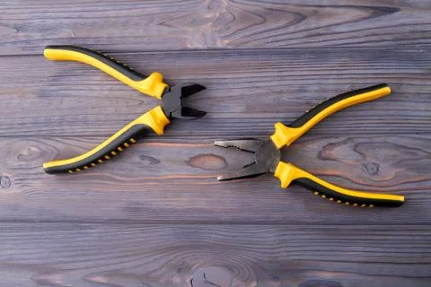 Two hand tools pliers with rubber handles. Stock Photos