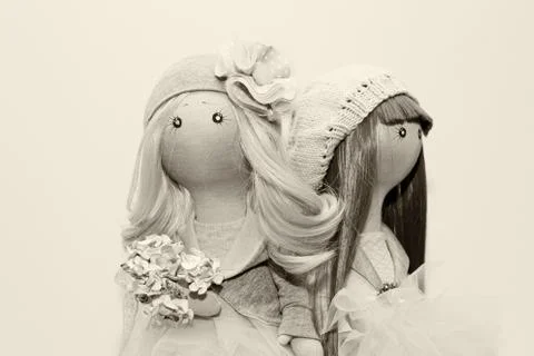 Two handmade rag dolls - blonde and brown-haired. sepia Stock Photos