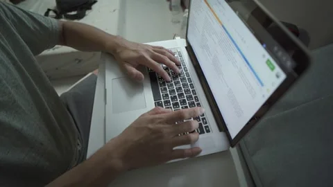 Two hands are pressed on the keyboard laptop in the bedroom. work form home Stock Footage 146395775