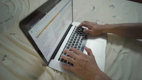 Two hands are pressed on the keyboard laptop in the bedroom. work form home Stock Footage 146395793