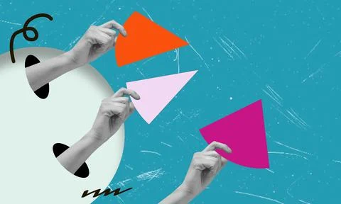 Two hands are seen skillfully placing vibrant triangular pieces of paper in p 写真素材