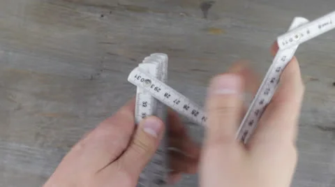 Two hands are struggling with a inch rule Stock Footage 24500367