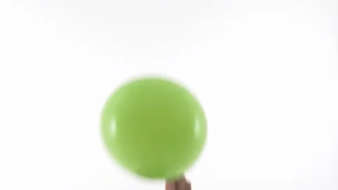 Two hands burst green balloon with needle Stock Footage 105408750