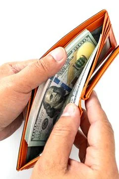 Two of hands carefully holds an open wallet overflowing with crisp banknotes. Stock Photos