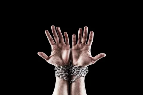 Two hands in chains isolated on black background with clipping path Stock Photos