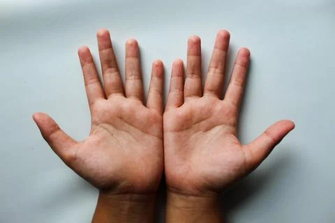 Two hands of a child on a white background Stock Photos