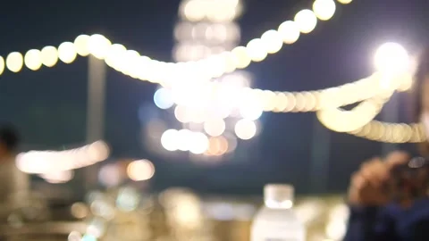 Two hands clinking cold beer cups at a night market with warm bokeh lights Video stock 309978823