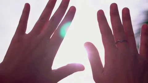 Two hands close up waving over the sunshine sky, slow motion Stock Footage 83502167