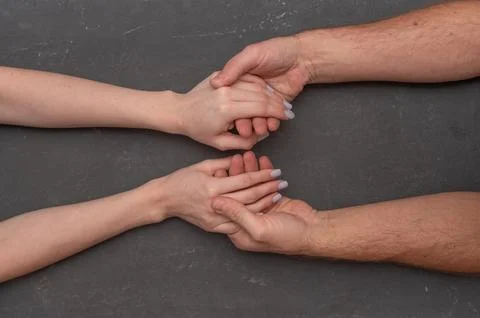 Two hands connected in gentle gesture reflecting trust, empathy, and human .. Stock Photos