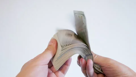 Two hands counting large stack of hundred dollar bills indoors Stock Footage 331225921