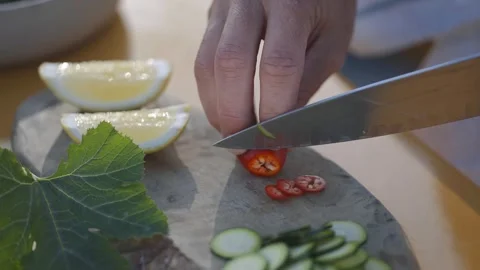 Two hands deftly chop a vibrant red chili Stock Footage 247054650