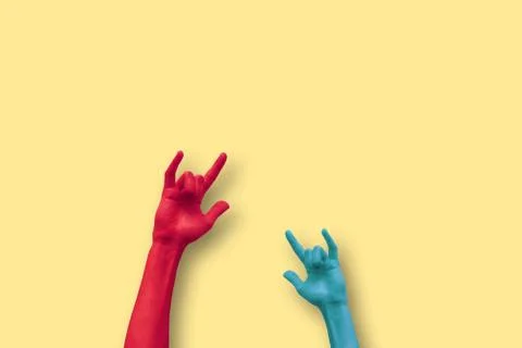 Two hands doing the sign of the horns in a minimalistic background Stock Photos