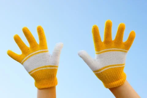 Two hands dressed in gloves Stock Photos