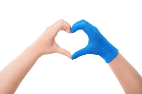 Two hands forming a heart shape, one bare and one in a blue medical glove, .. Foto stock