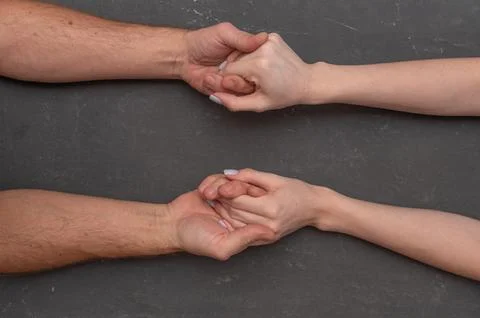 Two hands gently holding each other symbolizing support, compassion and emo.. Stock Photos