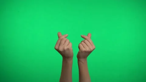 Two hands on a green background represent a Korean heart. Video stock 163599887