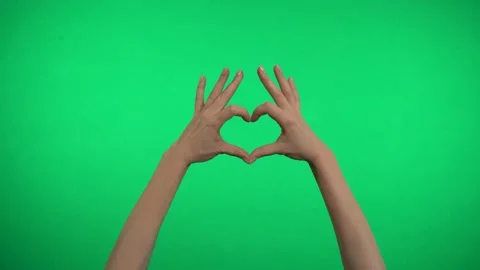 Two hands on a green background represent a heart. Video stock 163599895