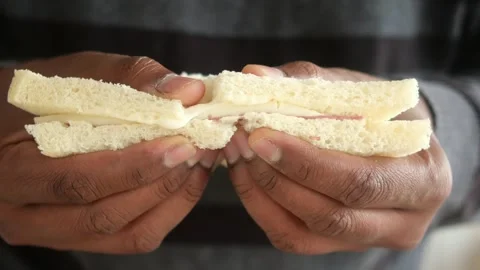 Two Hands Gripping a Basic Yet Delicious Sandwich Filled with Ham 스톡 동영상 297009110