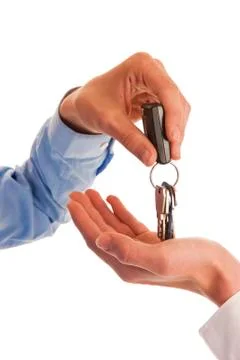 Two hands handing over keys Stock Photos