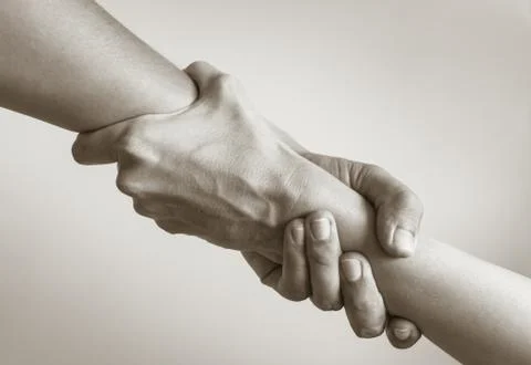 Two hands helping another. Stock Photos