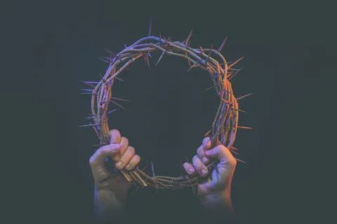 Two hands hold crown of thorns Stock Photos
