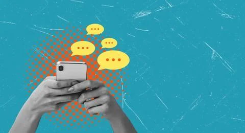 Two hands hold a smartphone with chat bubbles appearing above. The setting fe Stock Photos