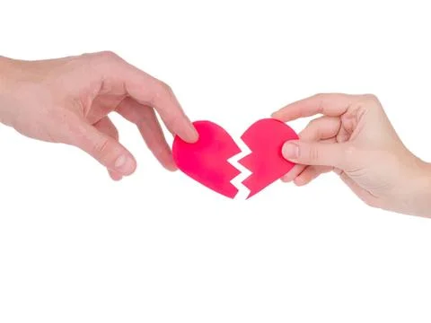 Two hands holding broken red heart symbolizing sadness Stock Photos
