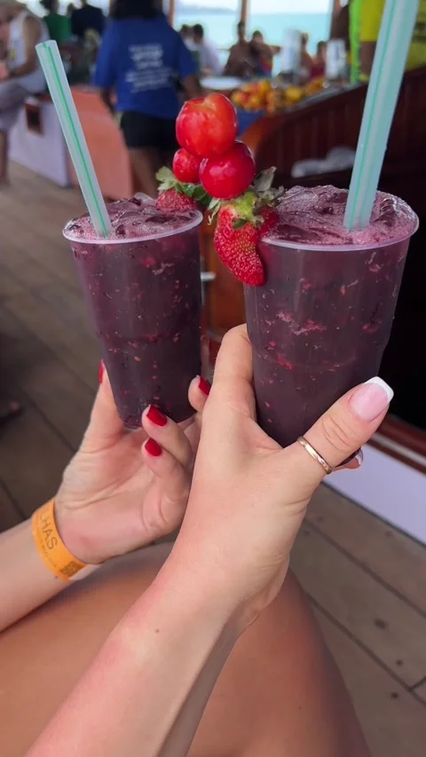 Two Hands Holding Fresh Berry Caipiroska Cocktails on Boat Tour Видео 343440914